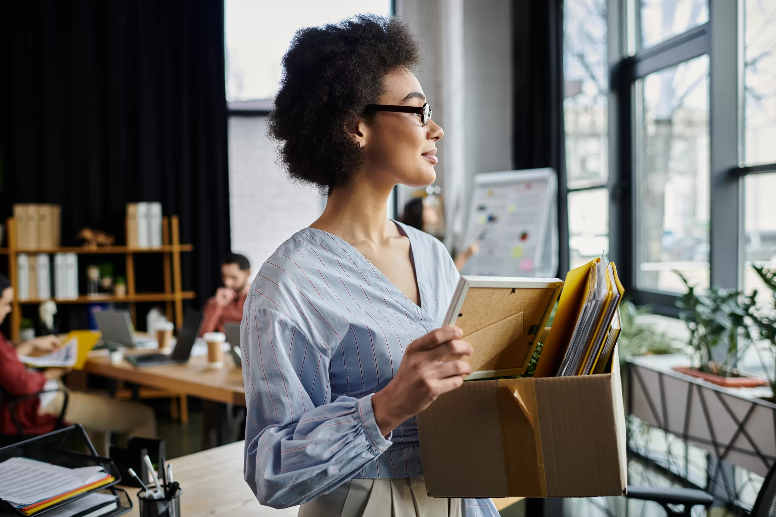 a woman holding a box with files